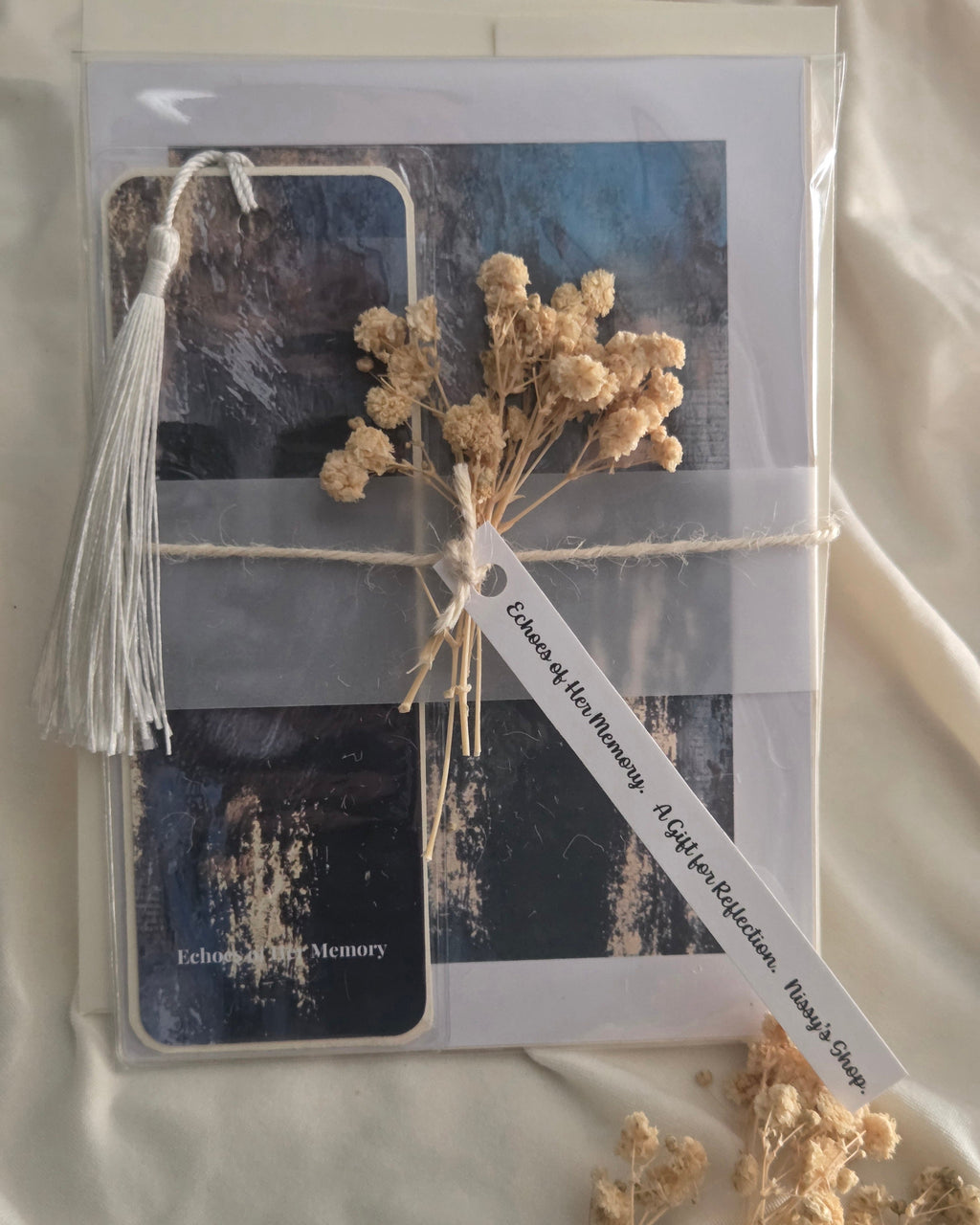 Packaged product with dried flowers and a tag on a neutral background
