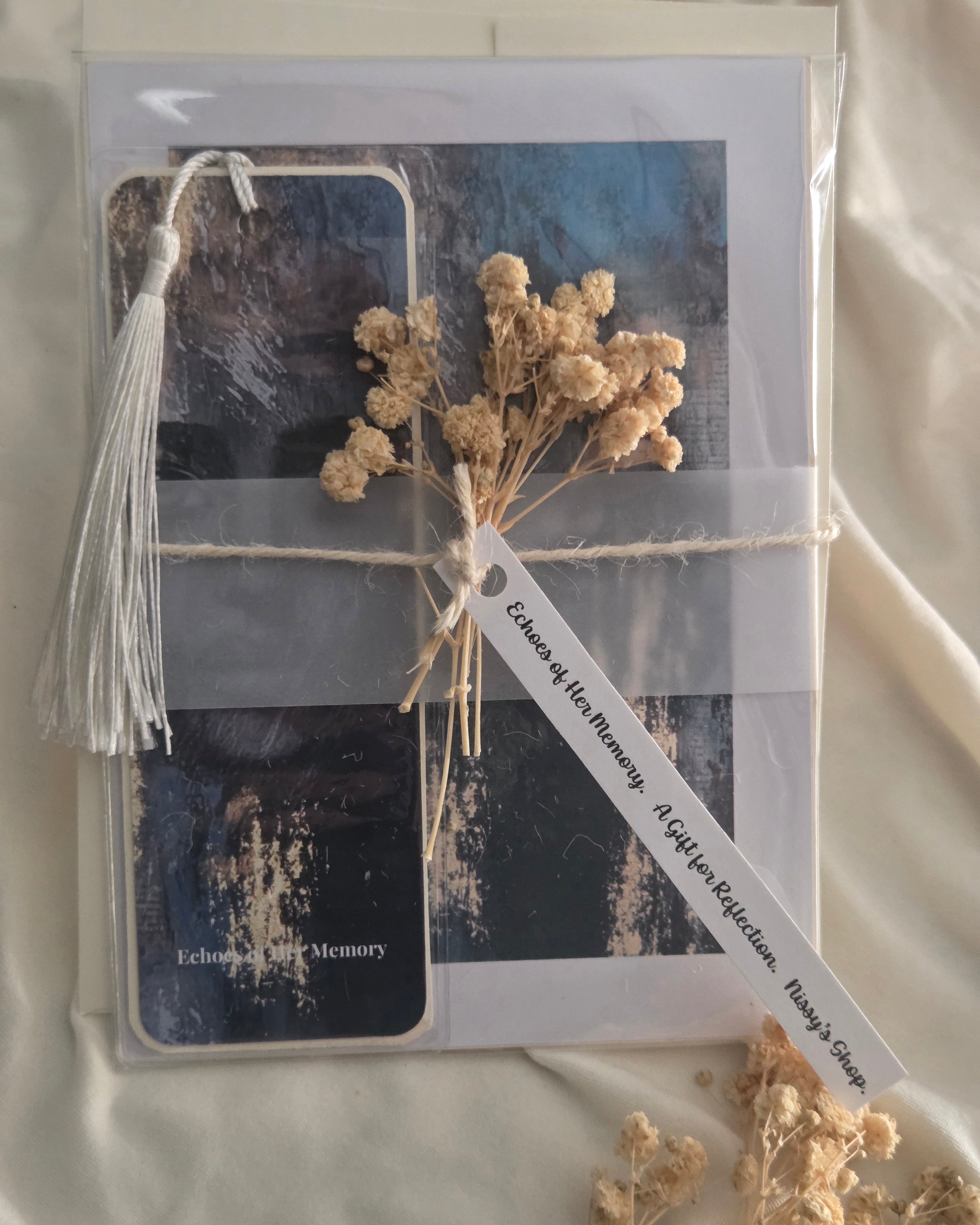 Packaged product with dried flowers and a tag on a neutral background