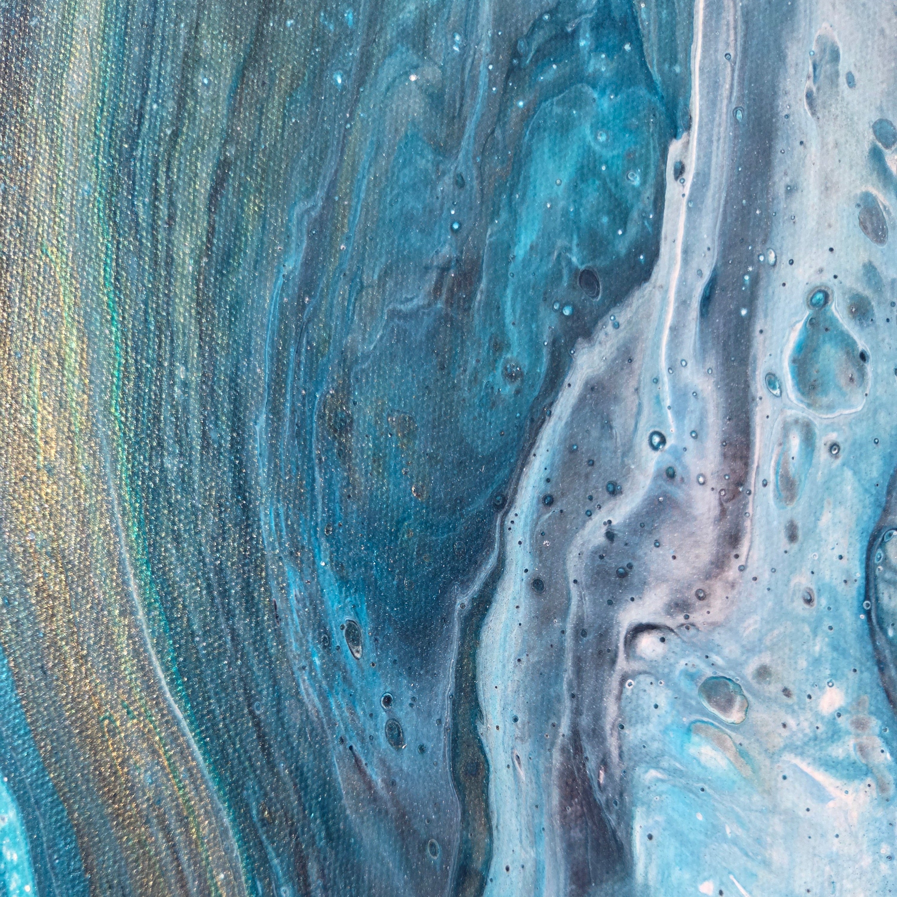 Blue, light blue, and gold fluid paint mimicking a marbled pattern.