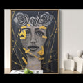 Framed artwork of a woman with roses on her head, bold gold elements around her face, and tears coming down her face.