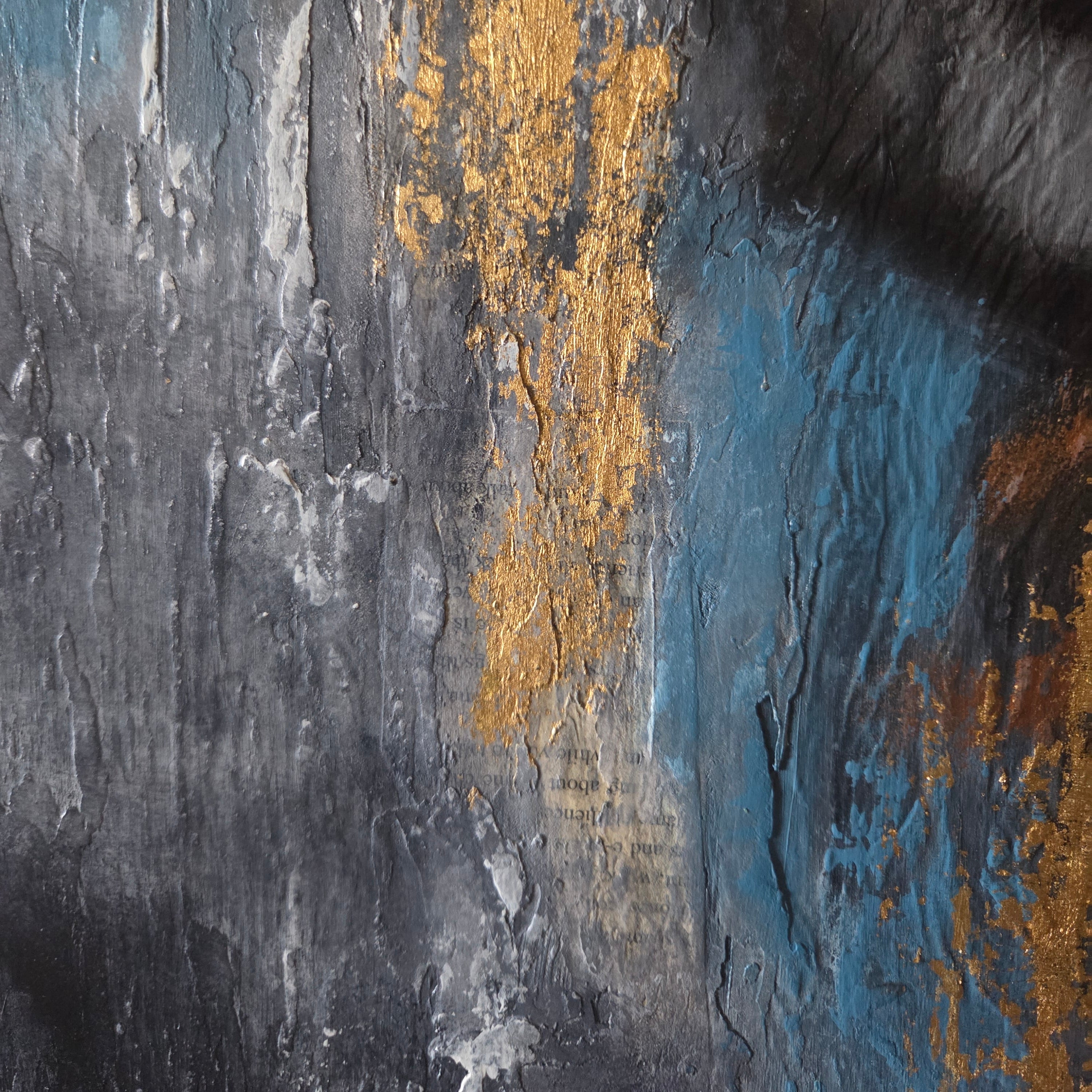 Close-up of a textured surface with gold accents and blue tones