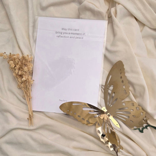 Greeting card with text, placed on beige fabric.