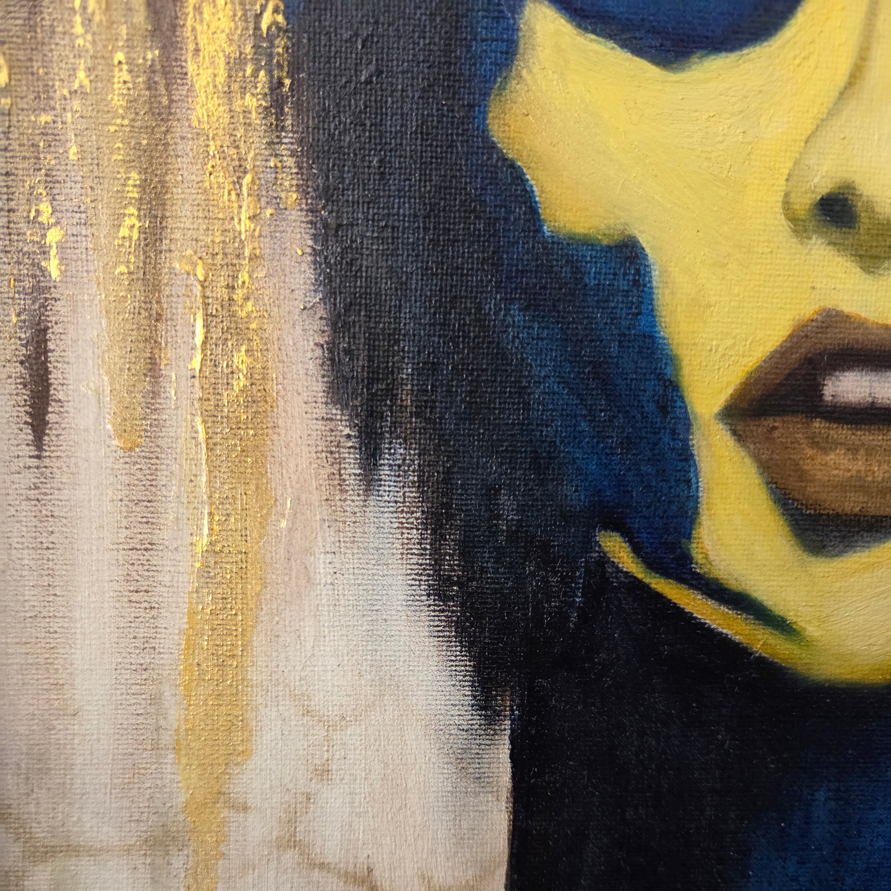 Close-up of a painting with abstract elements including blue, yellow, and gold.