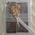 Packaged product with dried flowers and text on a neutral background