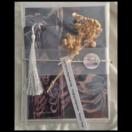 Packaged product with tassel, dried flowers, and text on a textured surface