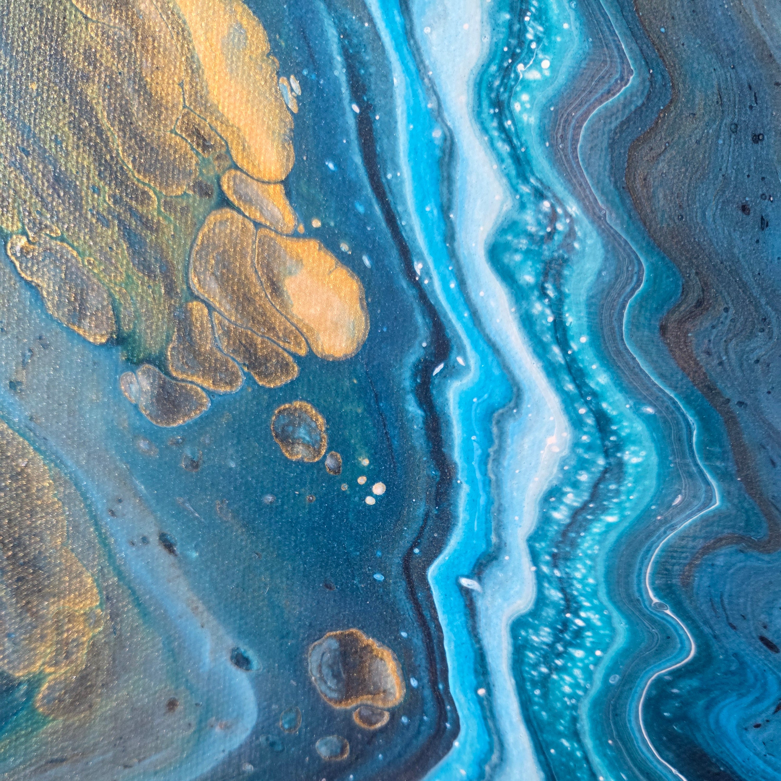 Close-up of a textured surface with blue, gold, and dark blue colors
