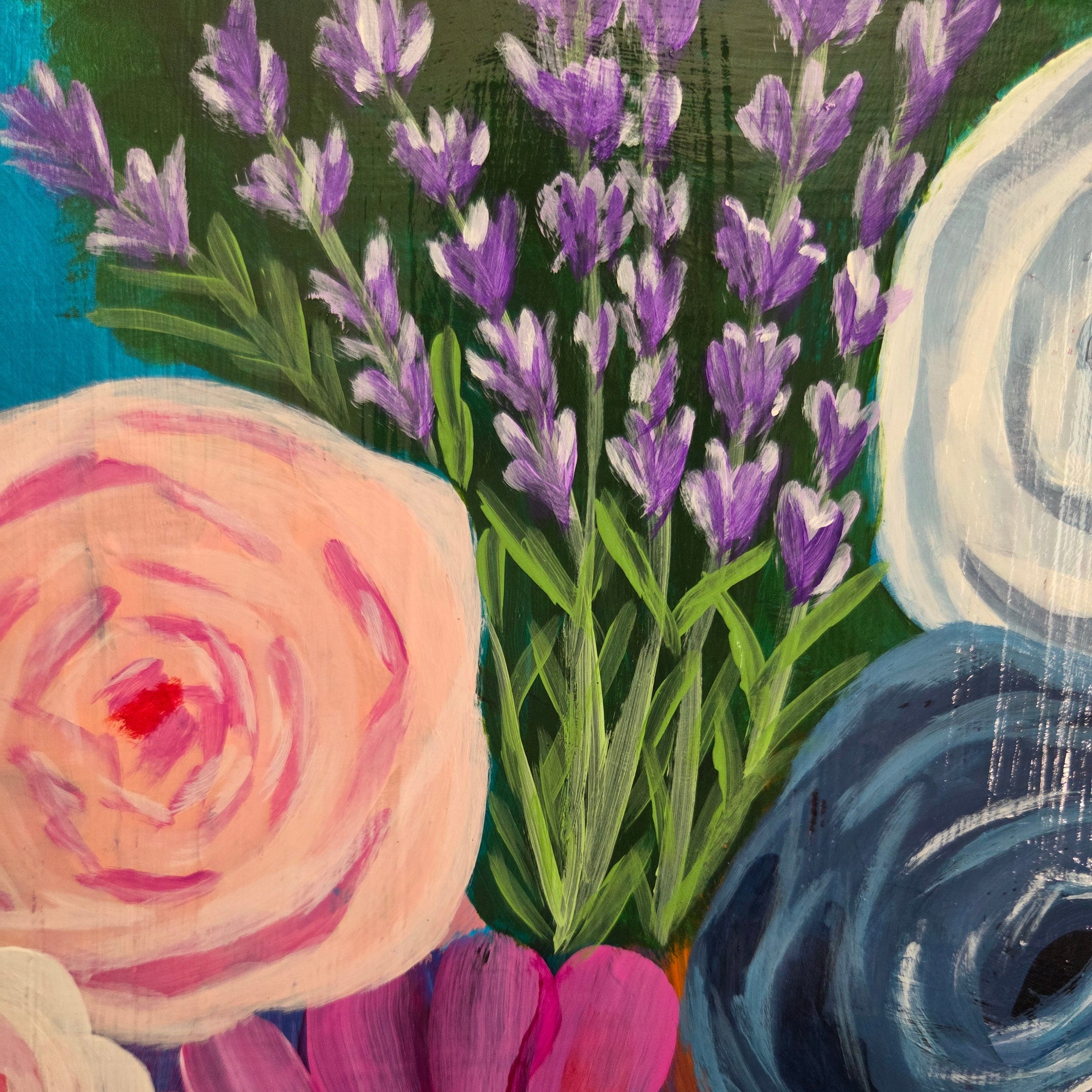 Colorful floral arrangement with lavender and roses on a textured surface.